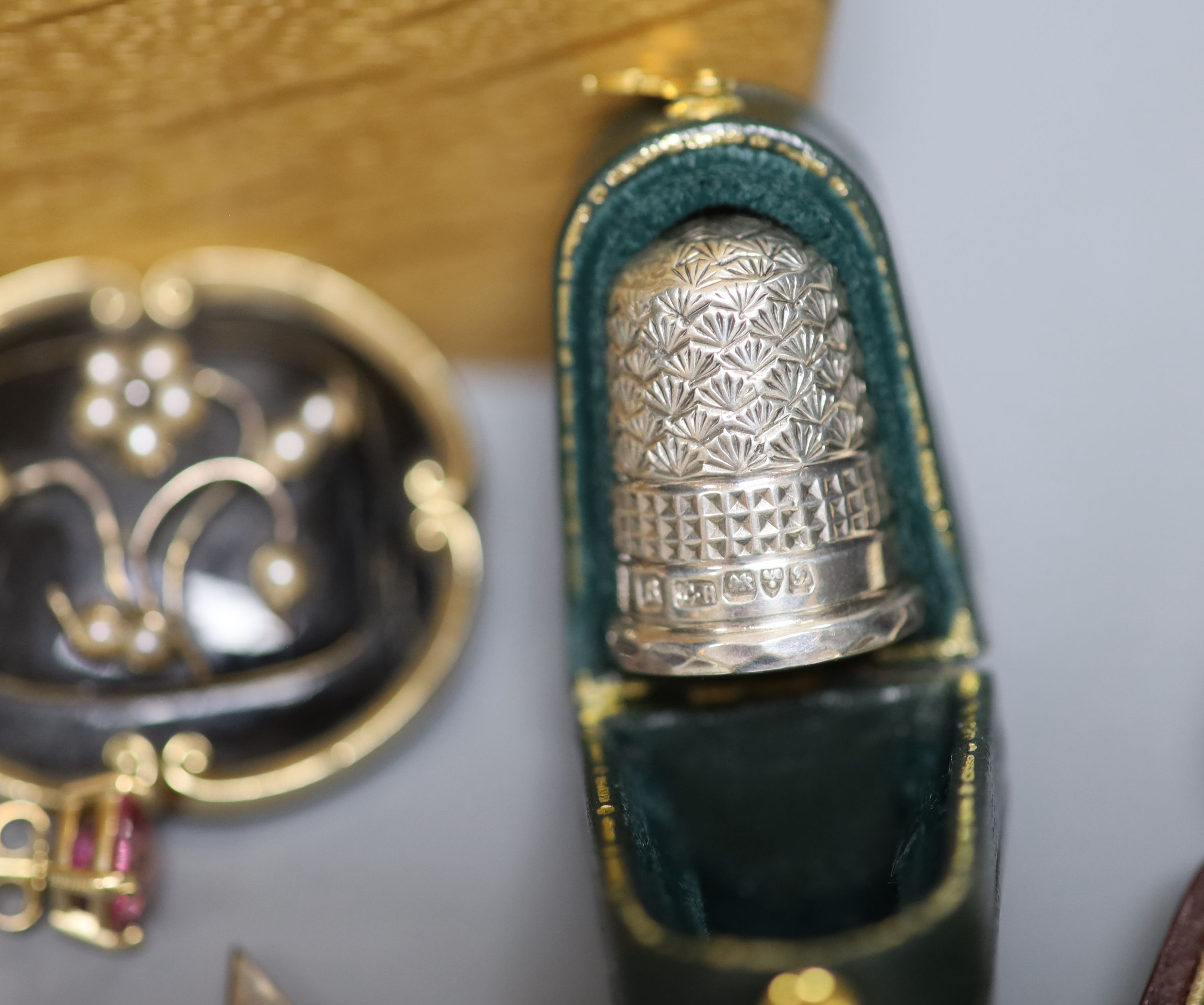 A group of assorted jewellery including two 333 yellow metal dress rings including coral set, a Victorian yellow metal, seed pearl and black enamel mourning brooch, cased silver Charles Horner thimble etc.